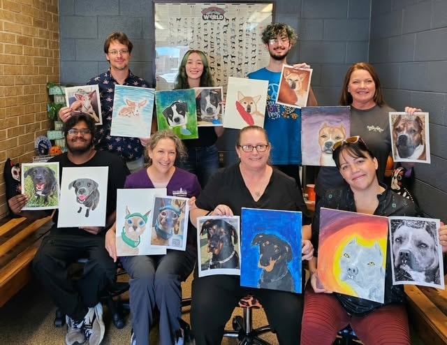 Cherokee Hills Veterinary Hospital team members displaying pet portrait paintings